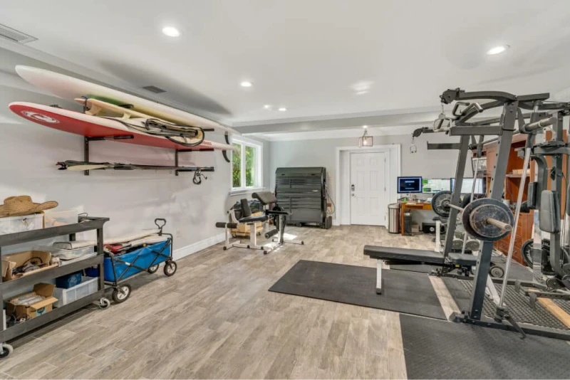 Custom home gym with assorted lifting and training equipment