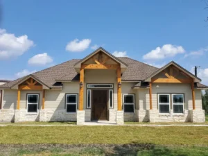 Custom home with wooden beams and the sky in the background