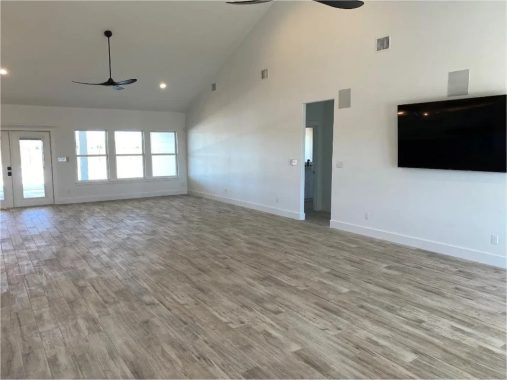 Spacious living room with wood flooring.