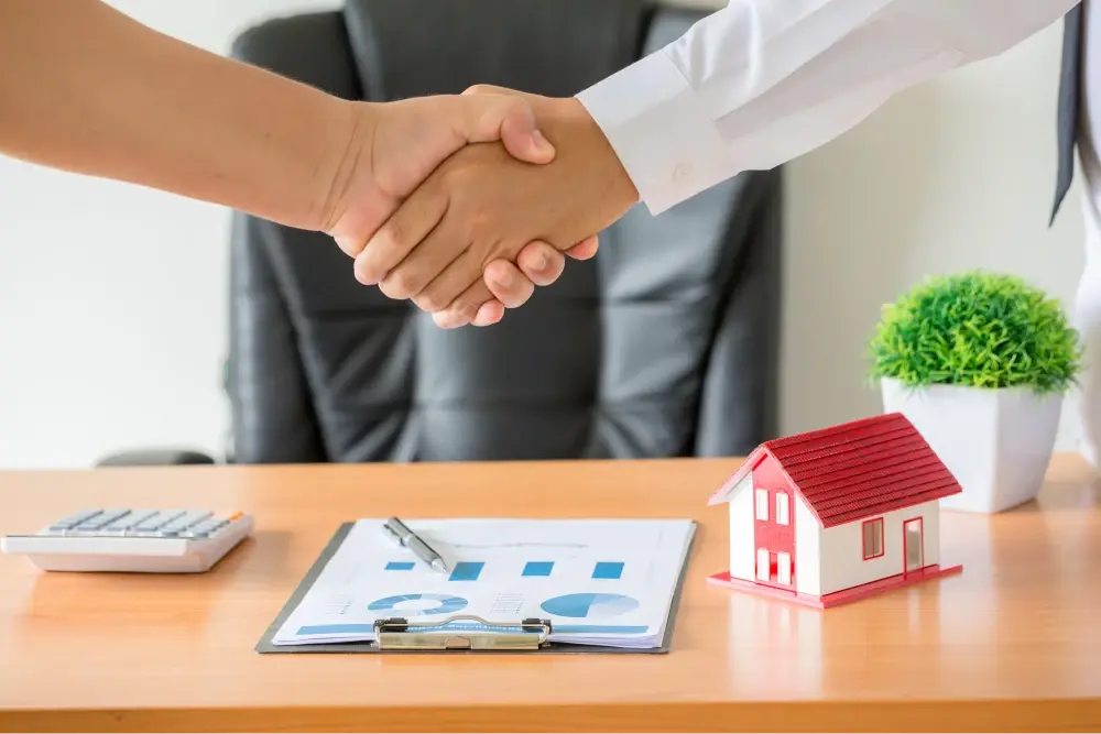 Handshake over real estate contract.