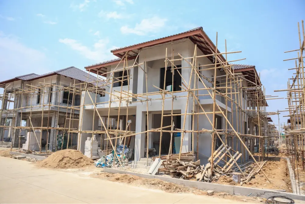 Houses under construction with scaffolding.