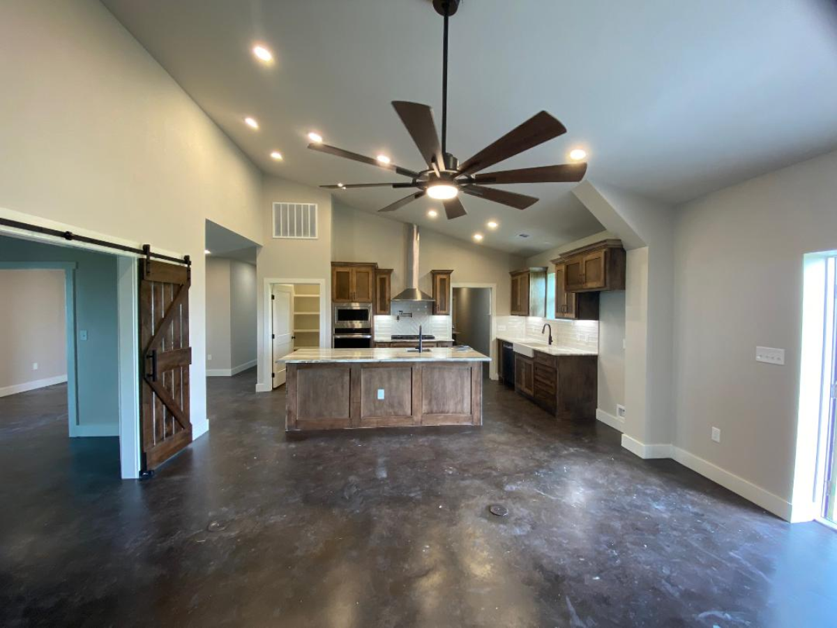 Kitchen with wood cabinets and a barn door.