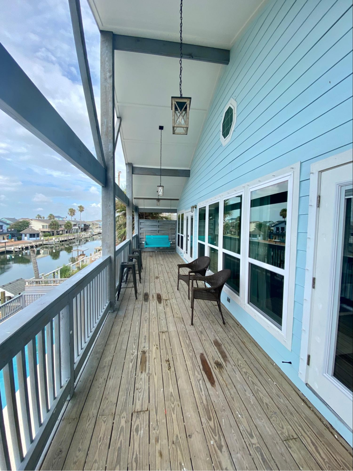 Balcony with blue siding and waterfront view.