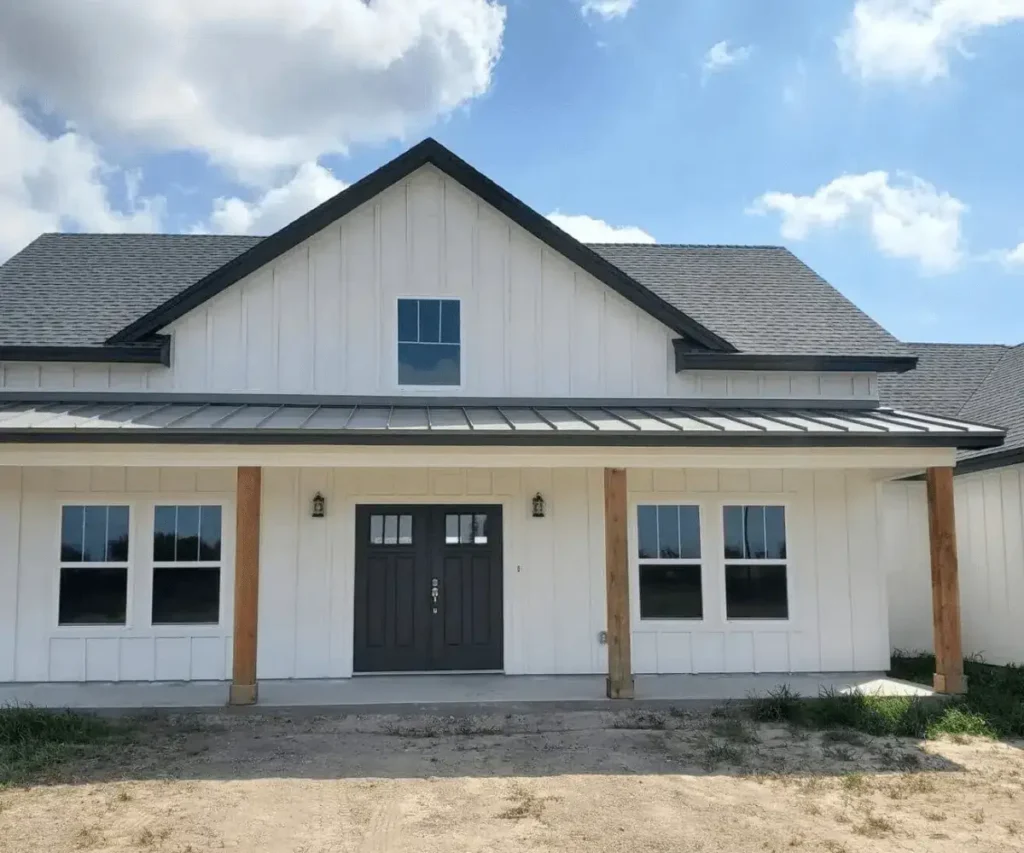 A simple yet modern home with a white exterior and a welcoming front porch.